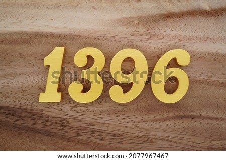 Golden Arabic numerals 1396 on a dark brown to white wood grain background.
