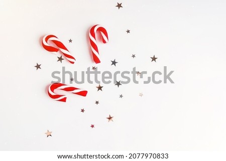New Year gifts.Christmas candies.Christmas and New Year background. Bright Winter holiday composition.Christmas composition. Gifts, spruce branches, red decorations on a white background.