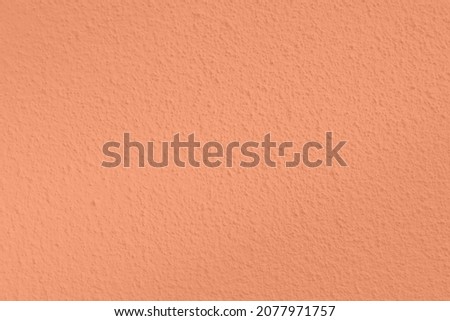Seamless texture of calm orange cement wall a rough surface, with space for text, for a background.	