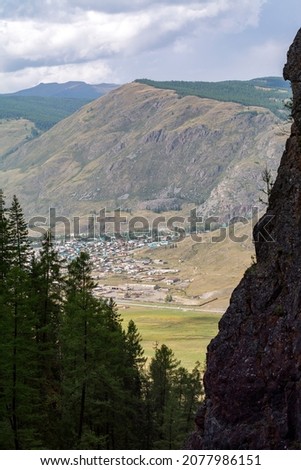 top view of a mountain village in summer, view from the gorge, first-person view, village in the mountains