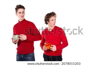 Two attractive guys are drinking coffee. White background.