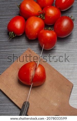 Tomato fruit on black striped background