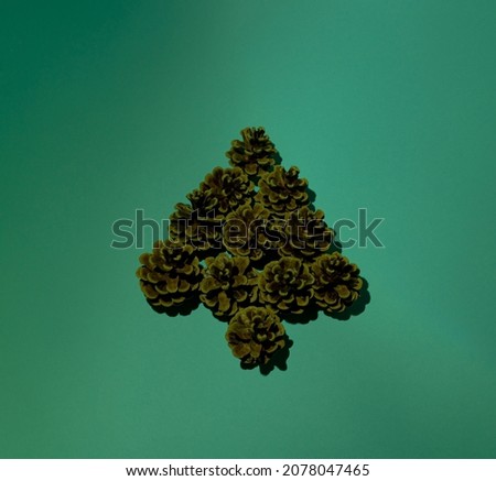 Christmas tree decoration on a green background. Minimal idea for the new year.
