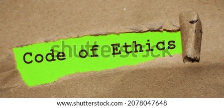 Text appearing behind torn brown envelop - Code of ethics. Royalty-Free Stock Photo #2078047648