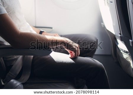 Man resting during flight. Legroom between seats in commercial airplane. 
 Royalty-Free Stock Photo #2078098114