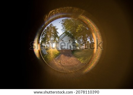 A beautiful view from the peephole to the house with large trees Royalty-Free Stock Photo #2078110390
