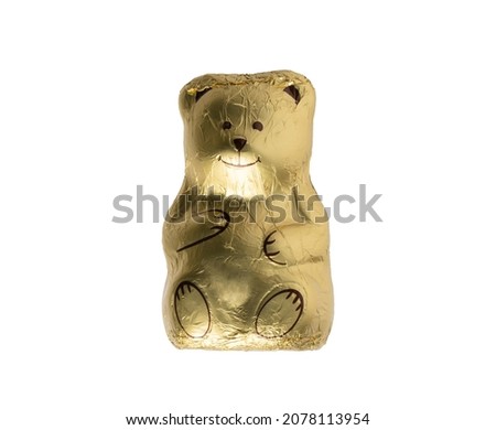 Chocolate teddy bear wrapped in gold foil isolated over white background
