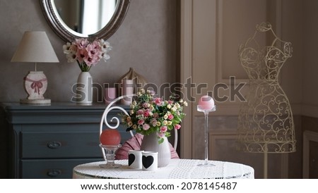 Bright interior with a window in soft colors. Fireplace and vases with flowers. Photo studio with a fireplace for family photography.