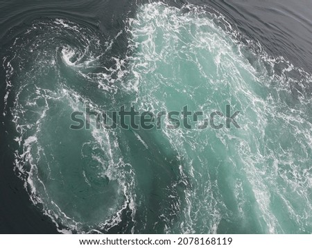 seawater, green with white foam, in the Arctic ocean