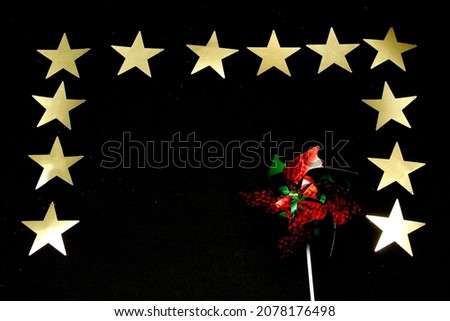 Sparkling stars as decorated frame for Christmas messages with poinsettia flowers and pinwheels
