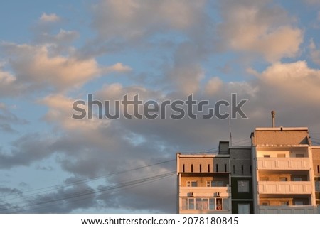 multi-storey building against the backdrop of a light blue cloudy sky