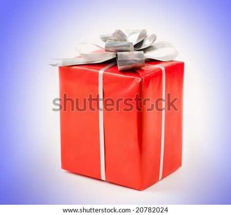 Photo of holiday gift in red box isolated over blue background