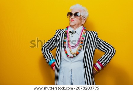 Funny grandmother portraits. Senior old woman dressing elegant for a special event. granny fashion model on colored backgrounds Royalty-Free Stock Photo #2078203795