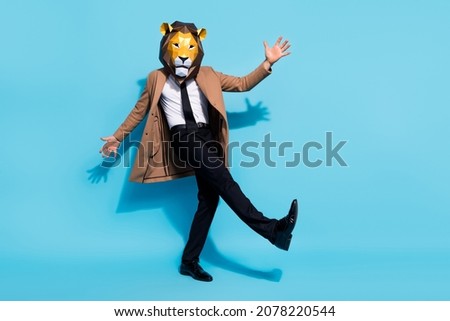 Full body photo of bizarre authentic guy lion mask dance incognito theme costume occasion isolated over blue color background