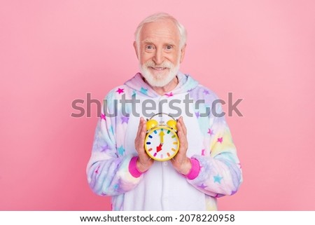 Photo of pretty handsome retired man nightwear overall smiling holding clock isolated pink color background Royalty-Free Stock Photo #2078220958