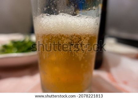 A close-up shot of bubbles in a beer glass 