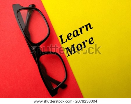 Glasses with text learn more on a colorful background.