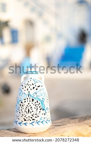 White and blue architecture on Santorini island on blurred background Traditional greek house and church in selective focus. Vacation and travel concept. Vertical photo