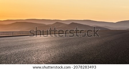Empty asphalt road and mountain scenery at sunrise Royalty-Free Stock Photo #2078283493