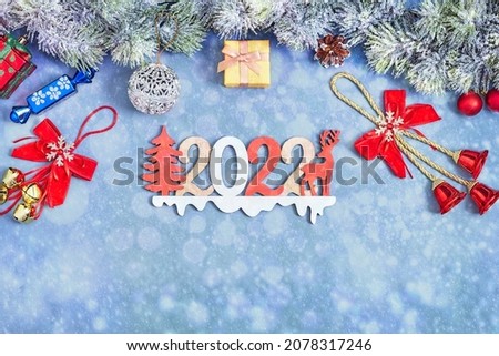 Flat lay. New Year. Noel. White Christmas gifts red ribbons, ornaments on blue background top view.