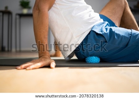 Glutes Trigger Point Massage Using Spiky Ball Myofascial Release Royalty-Free Stock Photo #2078320138