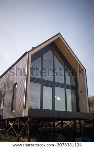 Barnhouse, Barn house. Wooden secluded house in the Scandinavian and Finland modern style with large windows. Exterior.