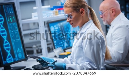 Professor and doctor work in a modern scientific laboratory using equipment and computertechnologies. Group of scientists make research and develop new vaccines. Science and healthcare concept. Royalty-Free Stock Photo #2078347669
