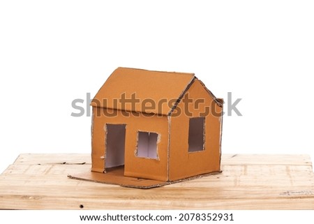 A home made cardboard home on a white background