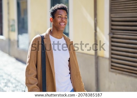Young Cuban man standing in the street.