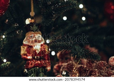 Christmas toy soldier Nutcracker figurine hanging on the Christmas tree. Traditional festive decor, New Year details