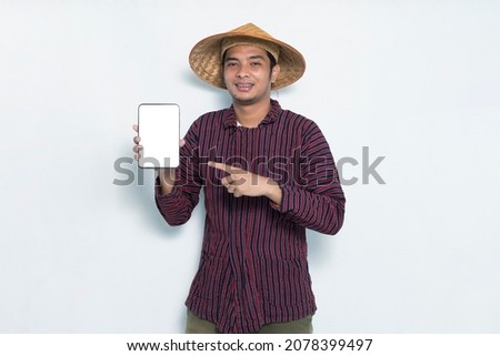 happy asian farmer demonstrating mobile cell phone isolated on white background