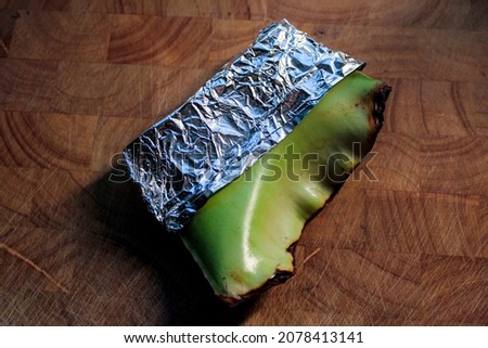 A piece of fresh aloe vera wrapped in aluminum foil to keep it fresh.