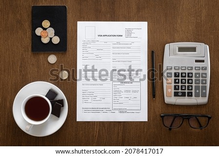 Visa application form on a wooden table, visa processing, registration, flat lay Royalty-Free Stock Photo #2078417017