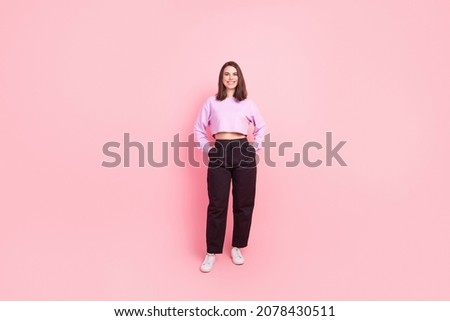 Full size photo of young cheerful lady hands in pocket confident wear modern outfit isolated over pink color background