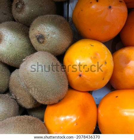 macro photo kiwi and persimmon fruit. Stock photo tropical fruits background