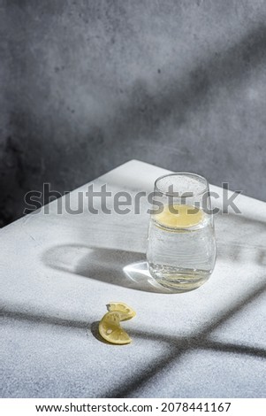 water with lemon on a gray background. High quality photo