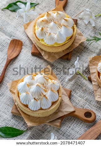 Set of sweet Lemon Merlingue tart on wood tray, set up for poster, cafe menu, restaurant menu, advertising, close up, food issue, selective focus.