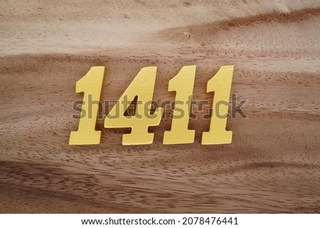 Golden Arabic numerals 1411 on a dark brown to white wood grain background.
