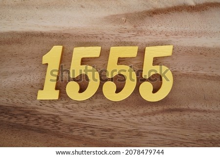 Golden Arabic numerals 1555 on a dark brown to white wood grain background.