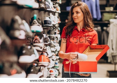 Young woman working at sportswear shop Royalty-Free Stock Photo #2078482270