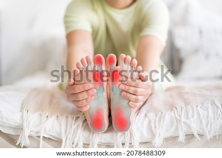 Joint diseases, hallux valgus, plantar fasciitis, heel spur, woman's leg hurts, pain in the foot, massage of female feet at home, health problems concept Royalty-Free Stock Photo #2078488309