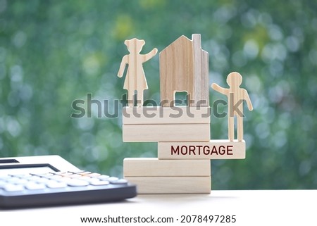 Love couple with model house and calculator on natural green background,Mortgage and real estate investment concept