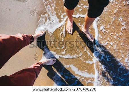 Foot selfie. Couple walking on the sandy seaside. Vacation theme
