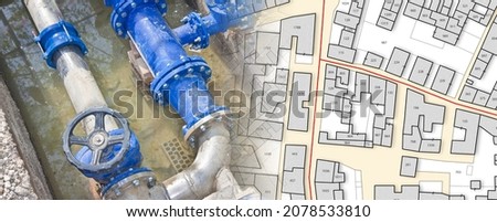 Construction site with new metal  hydraulic system of drinking water to be carried out under the road surface level and imaginary city map Royalty-Free Stock Photo #2078533810