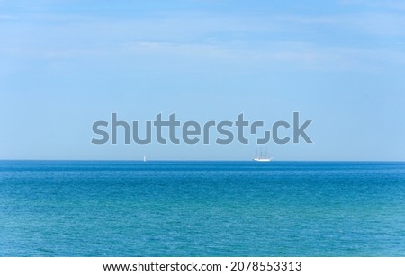 Ship on the horizon of the blue sea