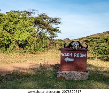 Outdoor Wash Room Sign with an Animal Skull in the Serengeti Tanzania