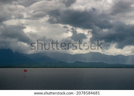 Beautiful landscape of lake and mountain during rainning in Thailand