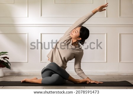 Calm of Asian woman in sportwear stretching muslce to warm up breathing and meditation with yoga at home,Healthy woman doing yoga Feeling so comfortable and relax,Wellness Yoga Healthcare Concept Royalty-Free Stock Photo #2078591473