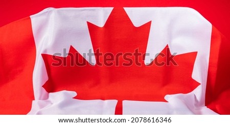 Canadian maple leaf flag on podium on red podium background. Mockup template banner
