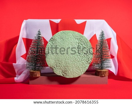 Christmas winter green podium festive scene mockup on red background with canadian flag. Holiday advertisement, greeting card template with fir trees
